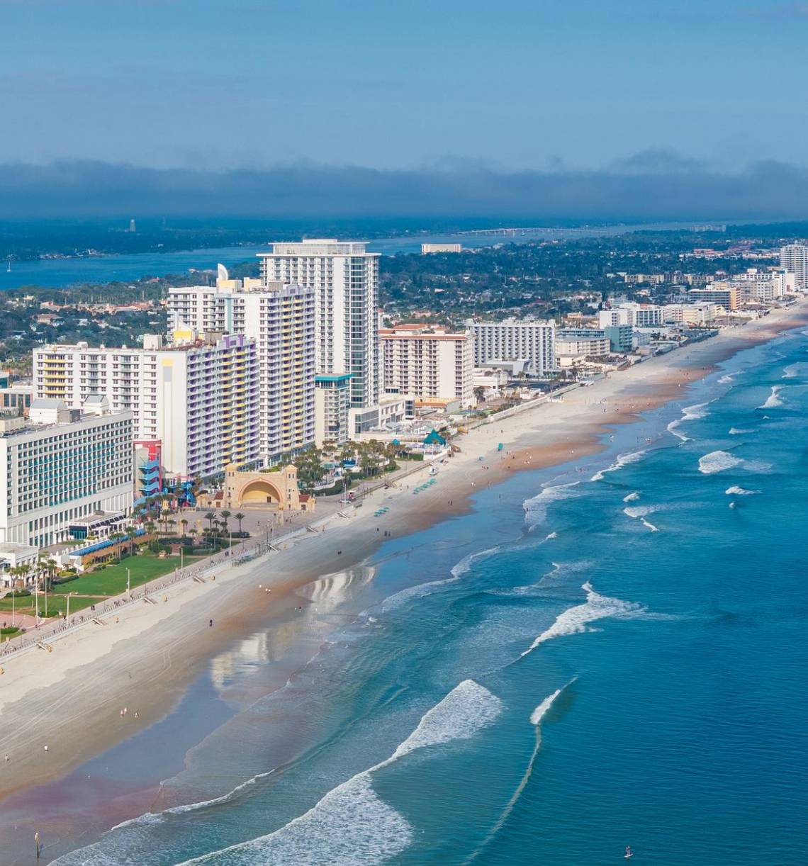 Coastal city skyline with beach waves