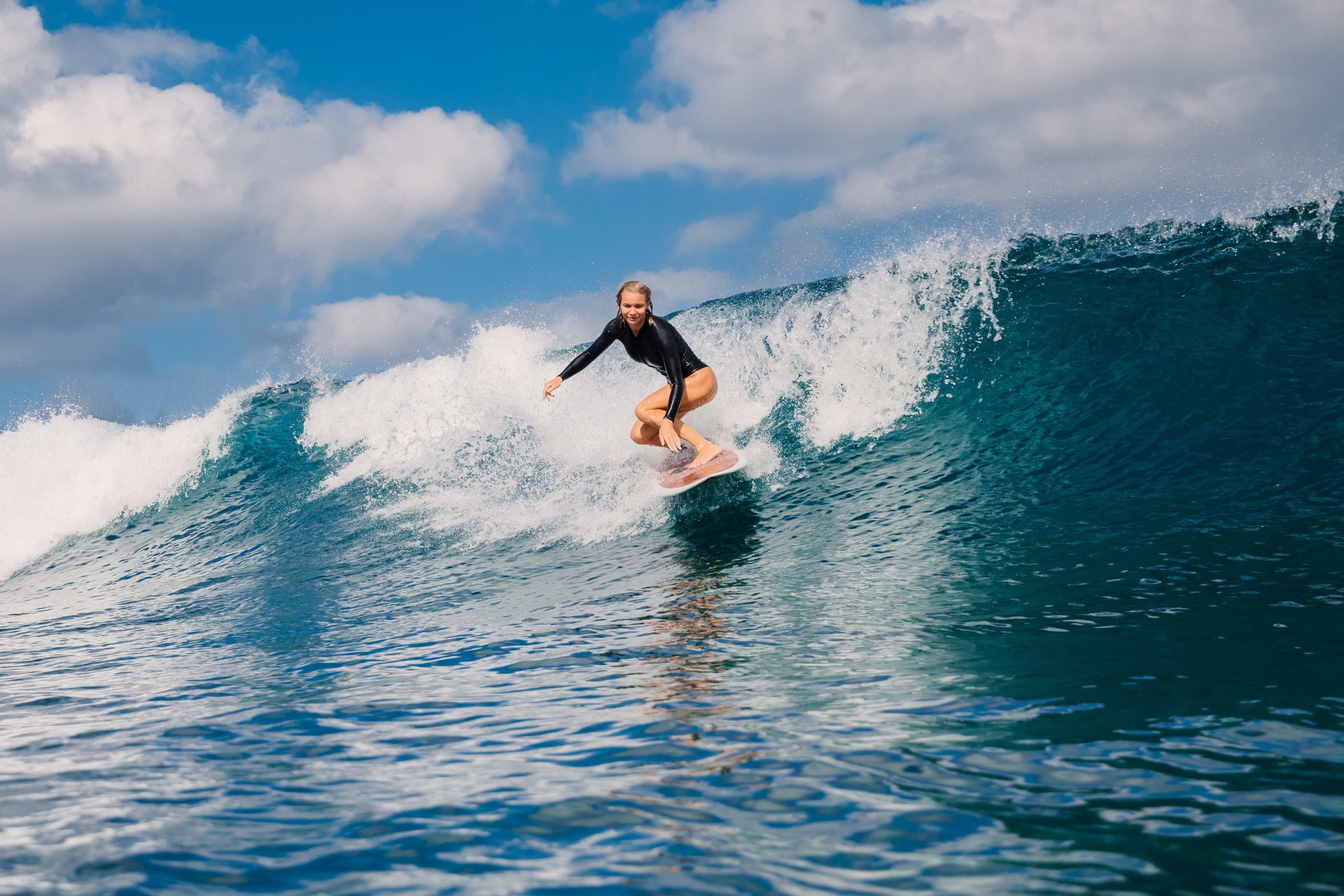 Person surfing on ocean wave