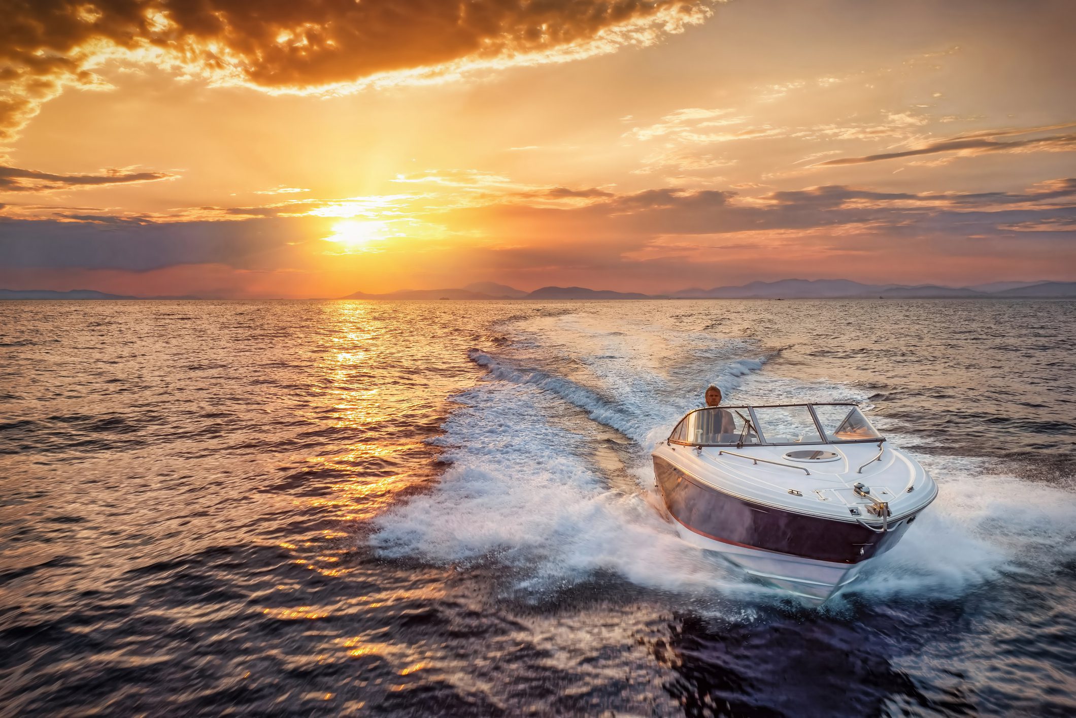 Speedboat cruising at sunset