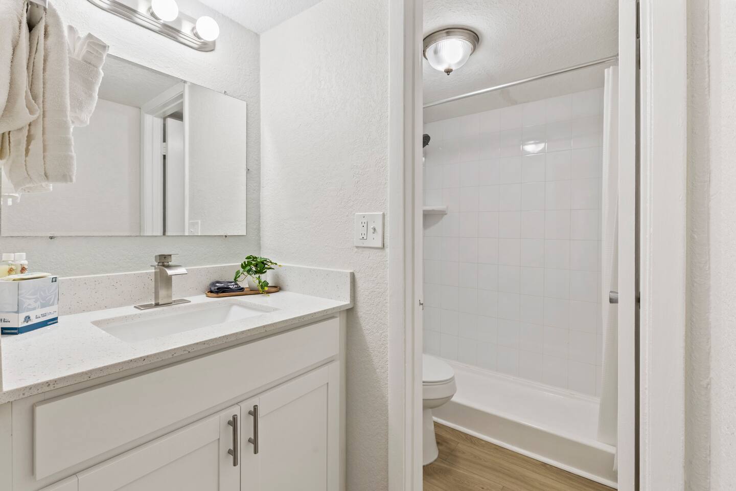 White bathroom with vanity and shower