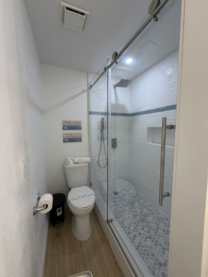 Small bathroom with glass shower and toilet