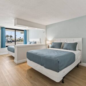 Hotel room with two beds and large window