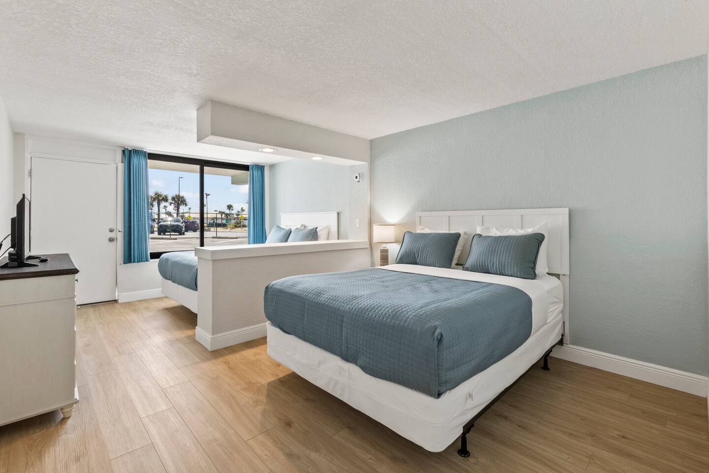 Hotel room with two beds and large window