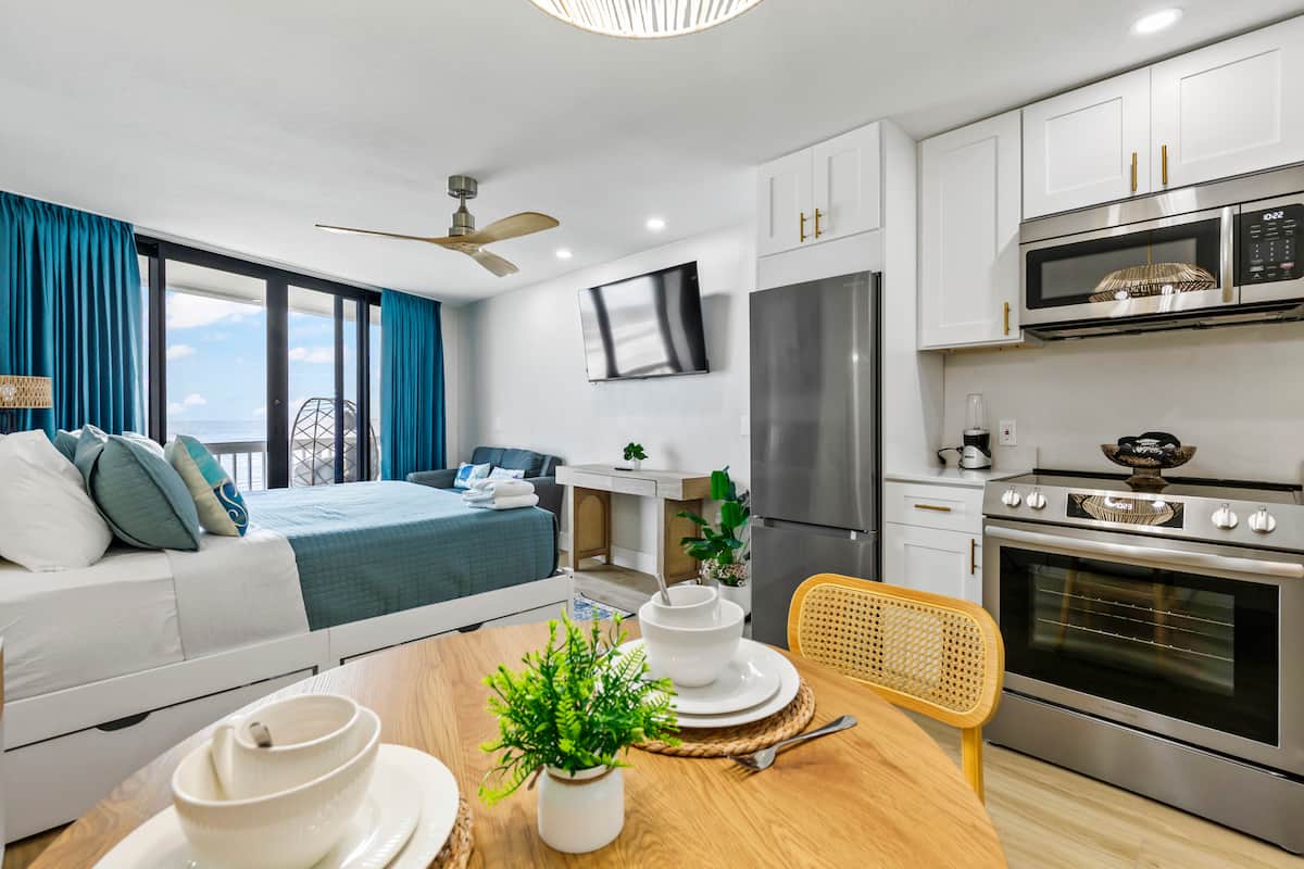 Coastal studio with kitchenette and balcony view