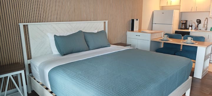 Modern studio apartment bed with teal bedding