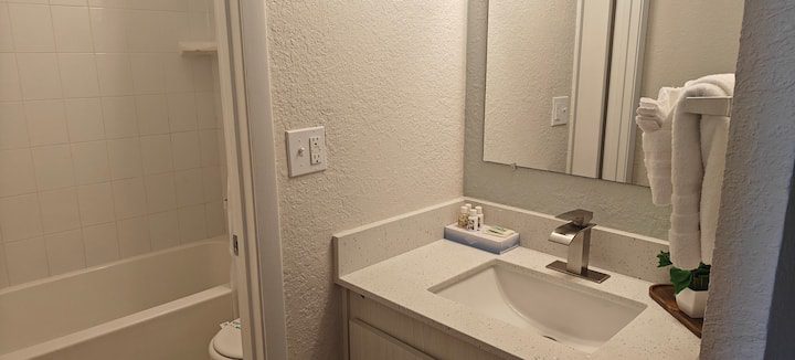 Modern bathroom sink with mirror and towels
