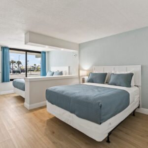 Bright coastal hotel room with two beds