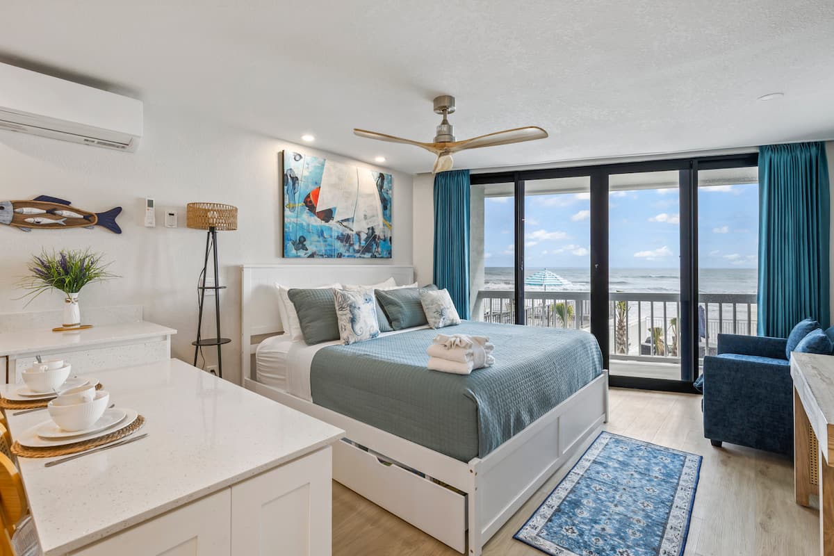 Cozy beachfront bedroom with ocean view balcony