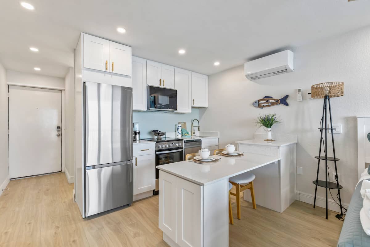 Modern white kitchen with island and stainless appliances
