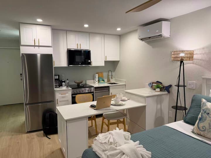 Modern studio apartment kitchenette and sleeping area