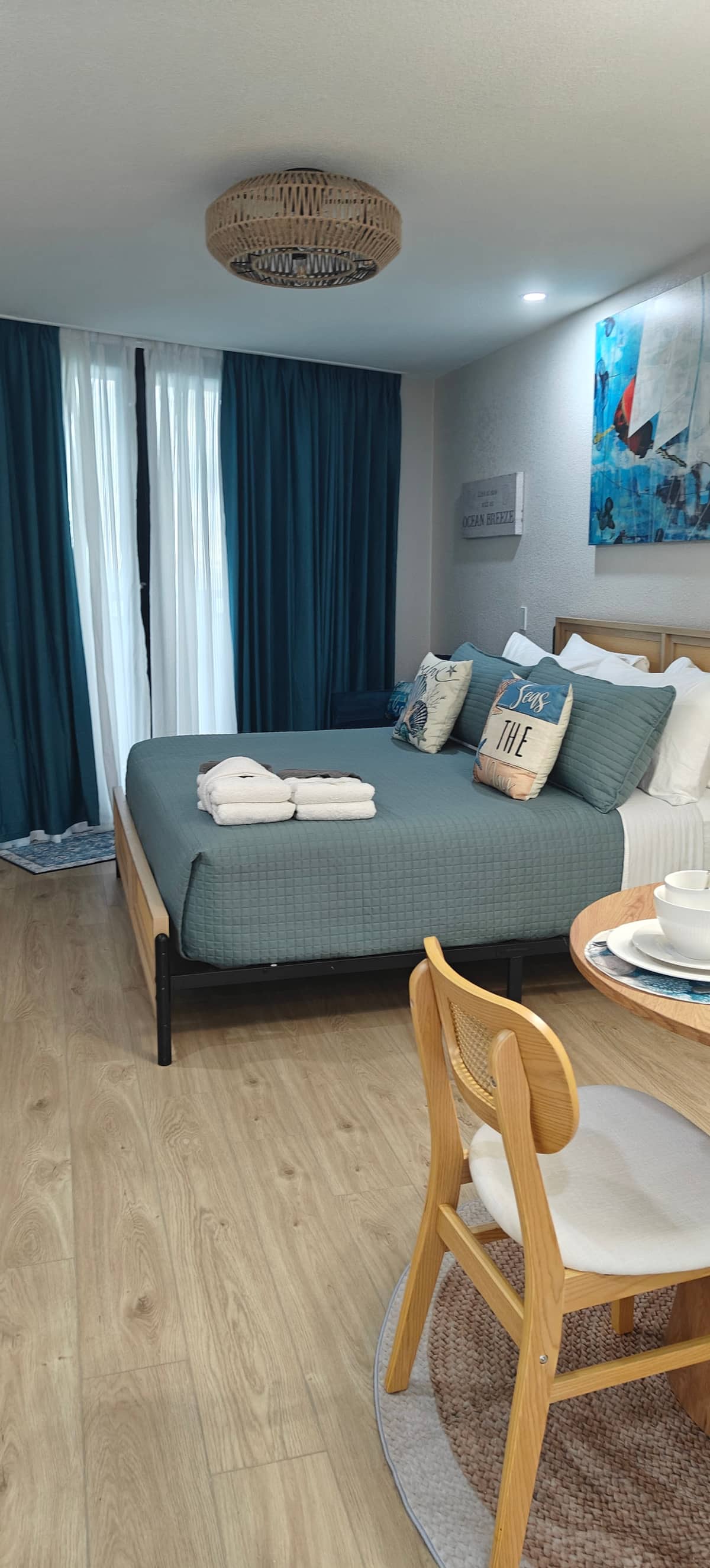 Cozy bedroom with teal bedding and towels