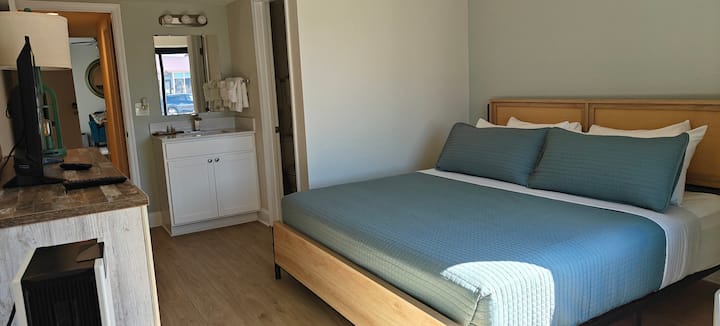 Cozy hotel bedroom with blue bedspread