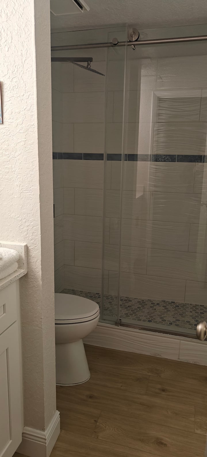 Compact bathroom with sliding glass shower door