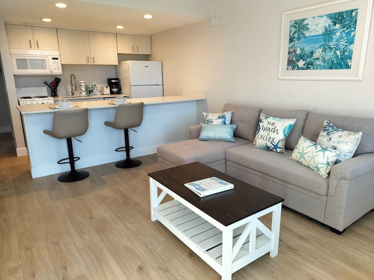 Open-plan coastal living room with kitchen
