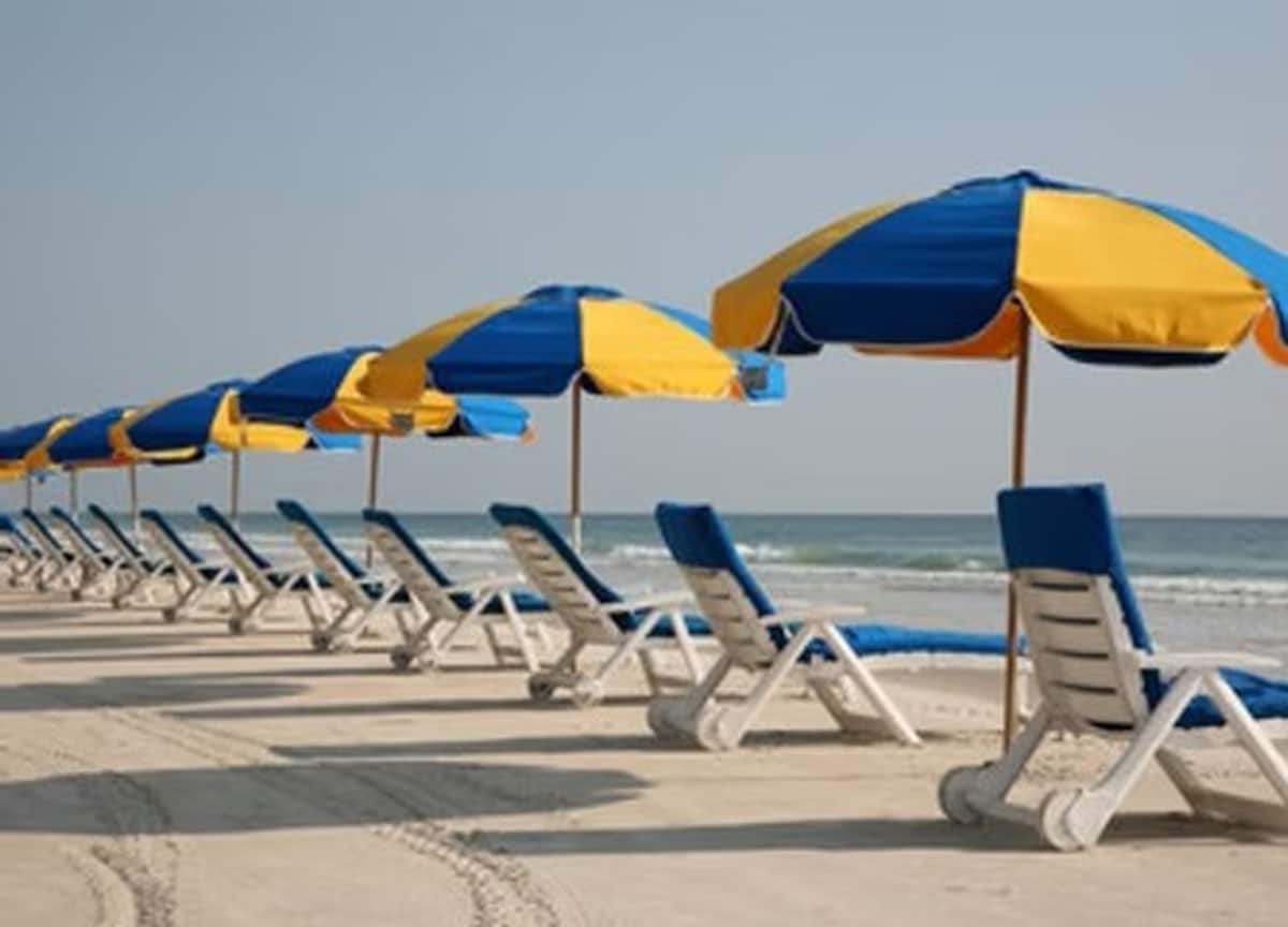 Blue and yellow beach umbrellas and chairs
