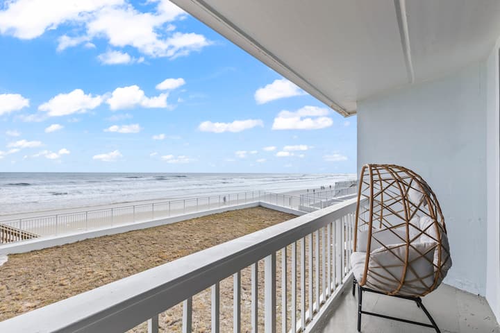 Oceanfront balcony with wicker egg chair