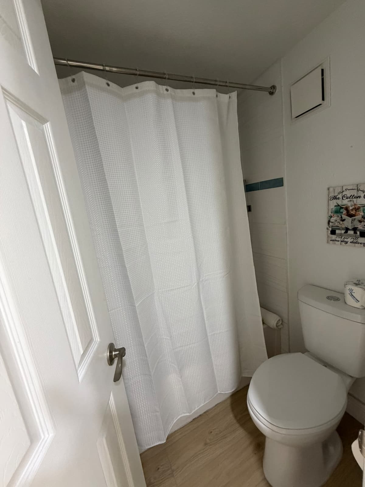 Small bathroom with toilet and shower curtain