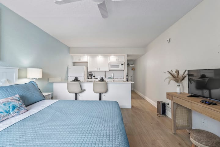Modern studio apartment with bed and kitchenette