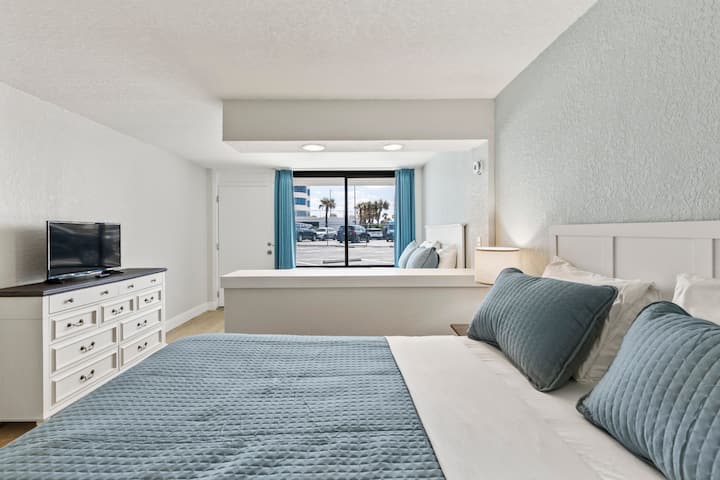 Modern bedroom with blue bedding and window view