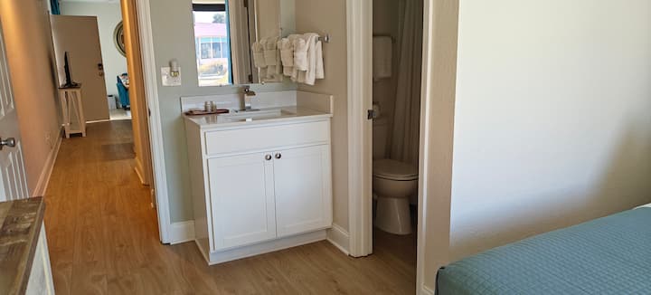 Bedroom with en-suite bathroom, vanity, towels