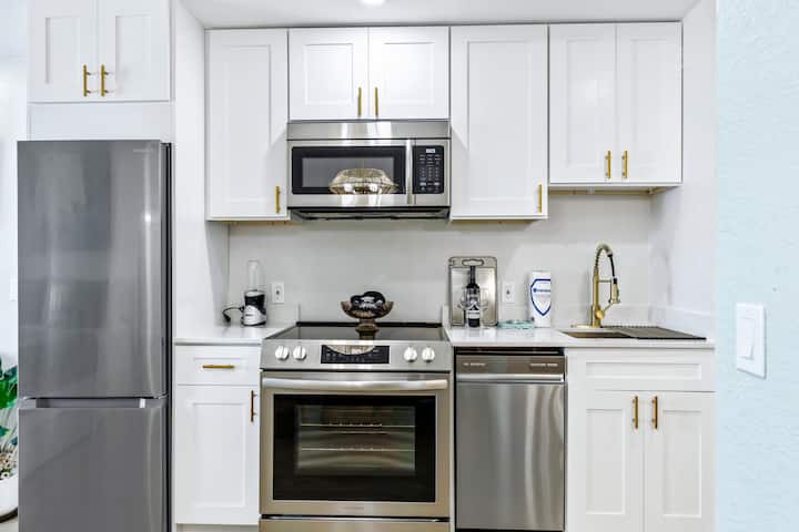 Modern kitchen with white cabinets and stainless appliances