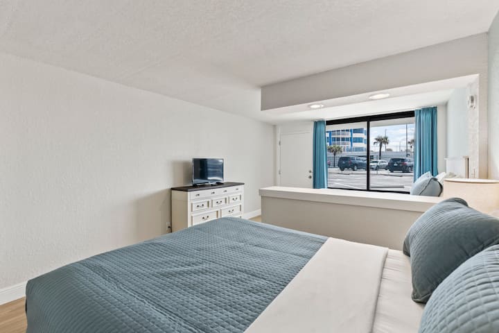 Cozy beachside hotel bedroom with blue bedding