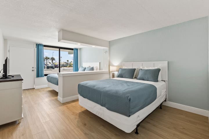 Bright hotel room with two queen beds