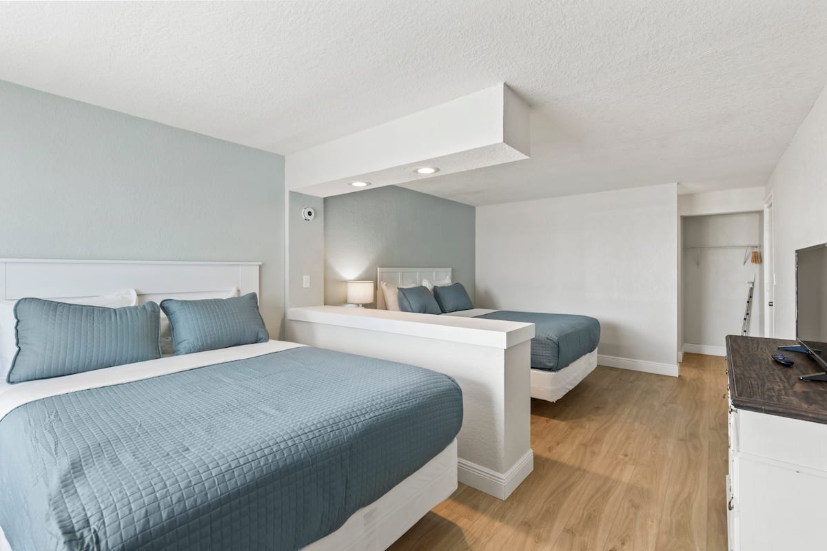 Spacious bedroom with two blue beds
