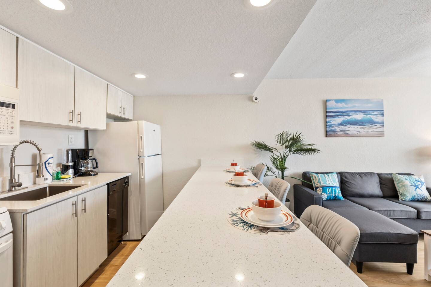 Beach-themed open kitchen island and living area