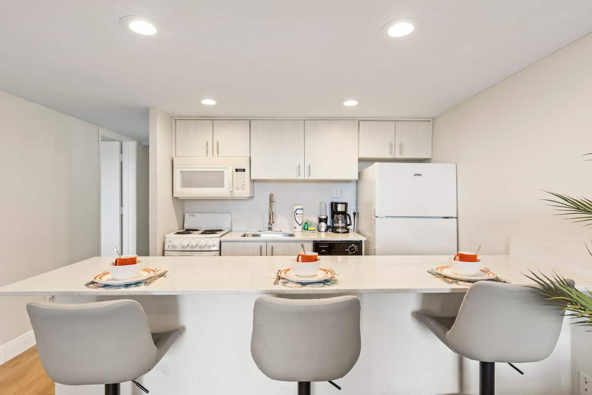 Bright modern kitchen island with three barstools