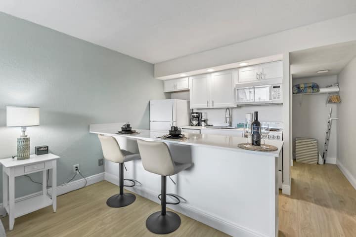 Modern white kitchenette with breakfast bar