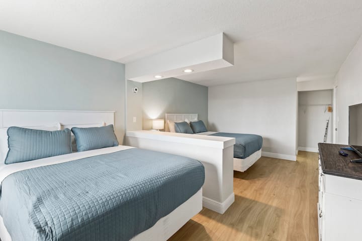 Bright modern room with two blue beds