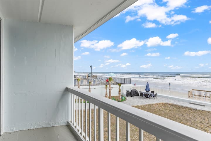 Covered balcony with white railing and sea view