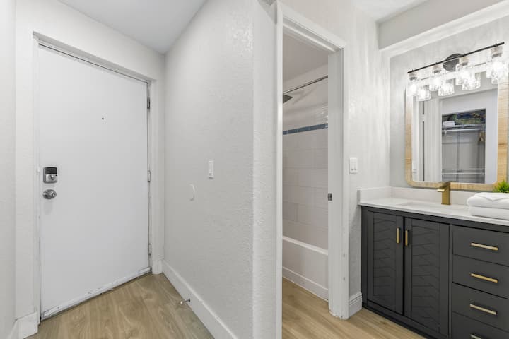 Entryway with bathroom and dark vanity