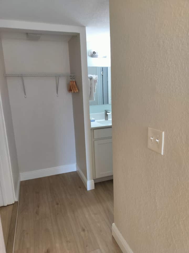 Hallway view into bathroom and empty closet