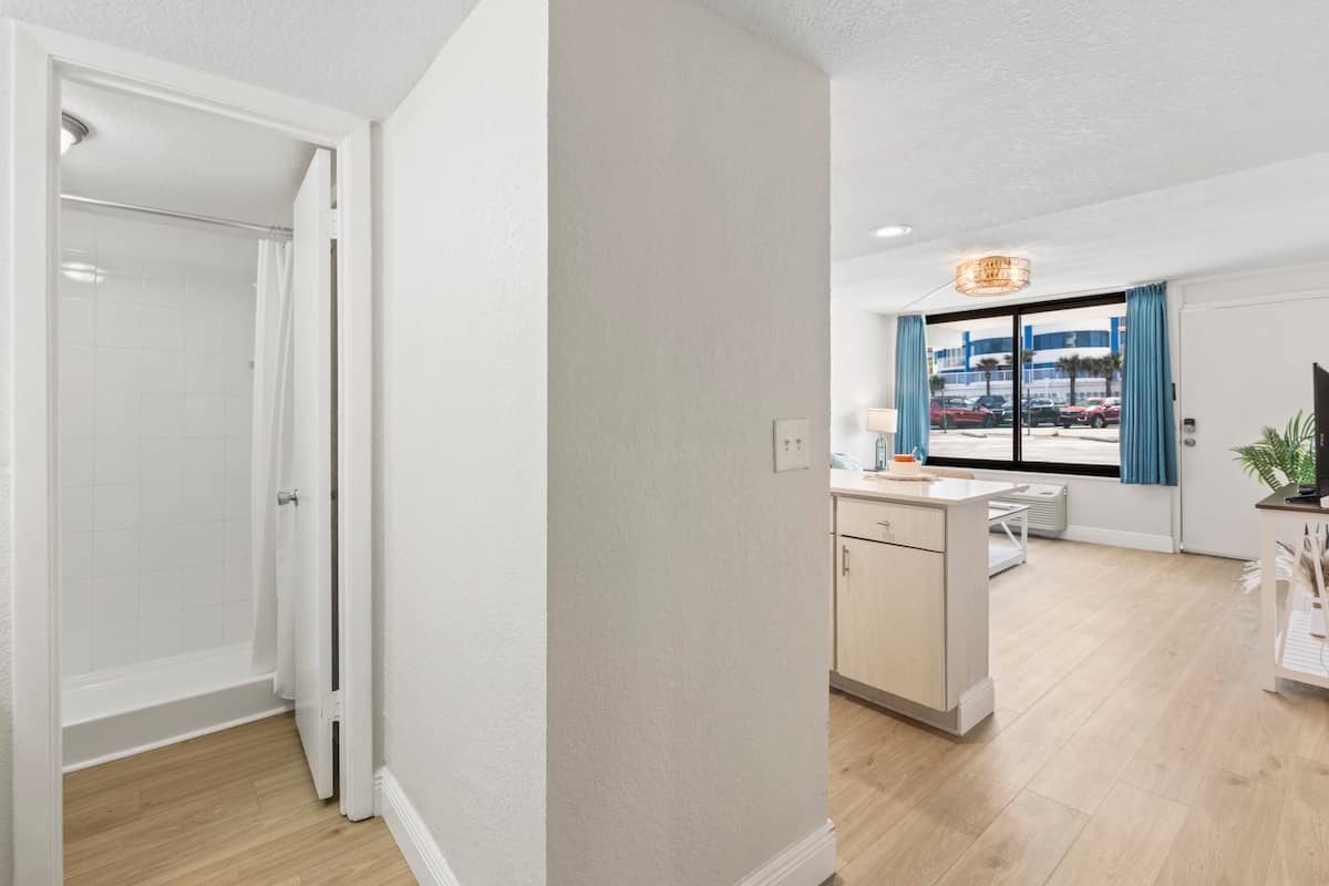 Cozy studio interior with open shower doorway